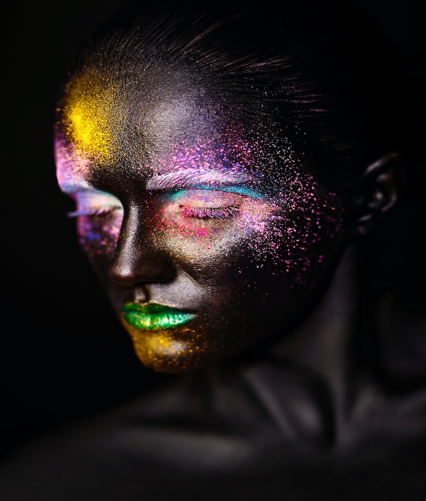 art photo of beautiful model woman with creative plastic unusual black mask bright colorful makeup with black face